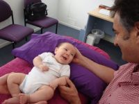 Joyaa treating a baby